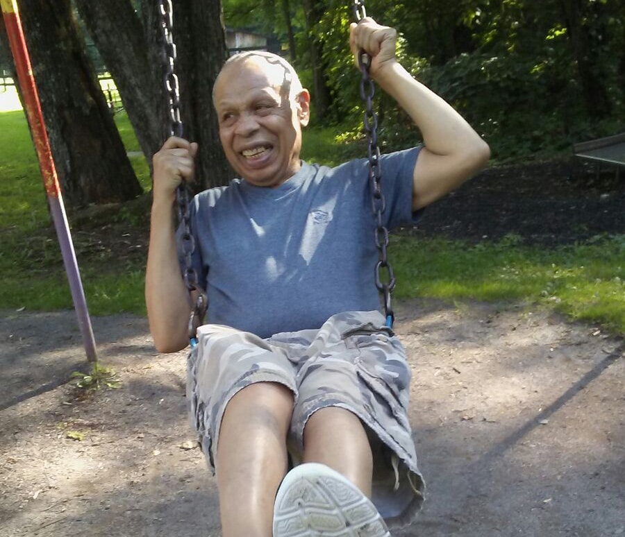 Man on swing in a park